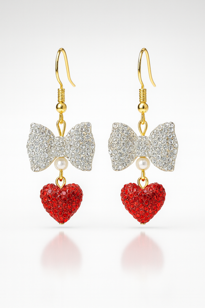 Grace-Tied Hearts Earrings with sparkling crystal bows and red hearts on gold hooks — faith-inspired, hypoallergenic jewelry symbolizing love and grace.