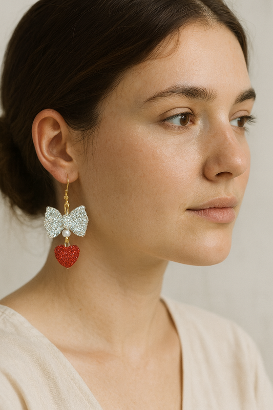 Grace-Tied Hearts Earrings with sparkling crystal bows and red hearts on gold hooks — faith-inspired, hypoallergenic jewelry symbolizing love and grace.