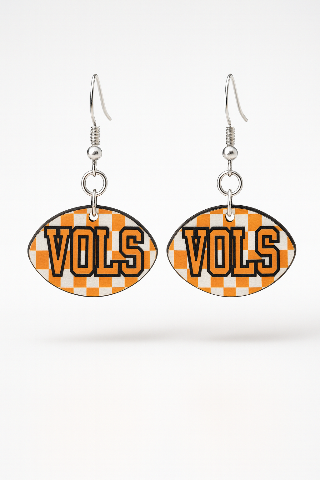“Orange and white checker football-shape earrings with nickel-free hooks on white background”