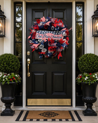 Faith & Freedom patriotic wreath displayed on a black front door with red white and blue Americana decor.