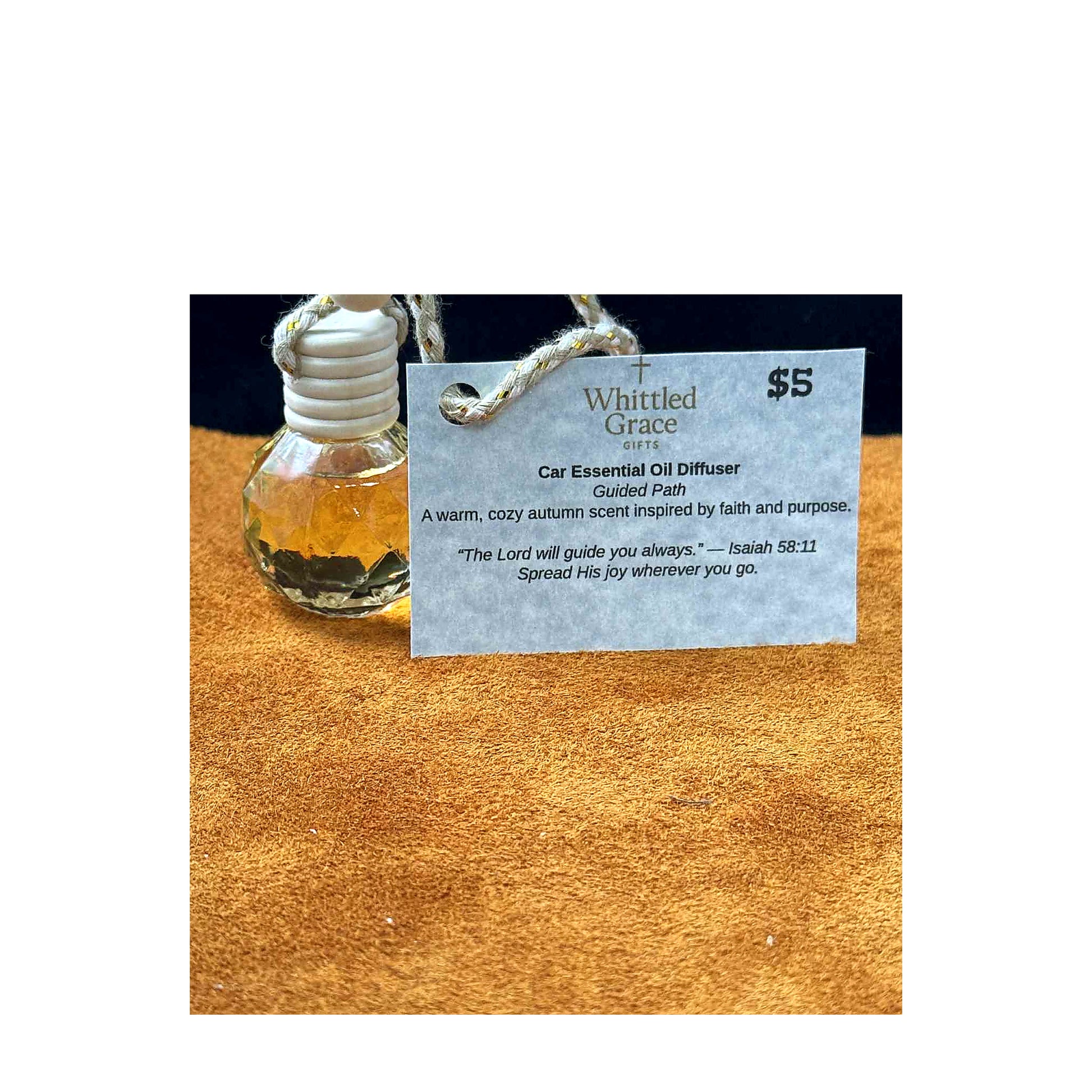 “Car diffuser with Guided Path tag, warm autumn scent on white background.”